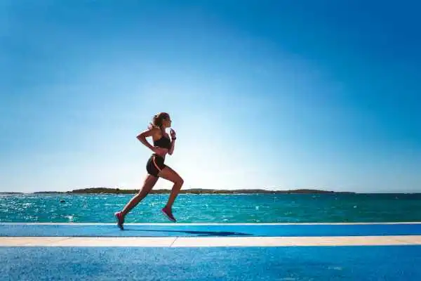 Woman running showing strong leg muscle Cheshire